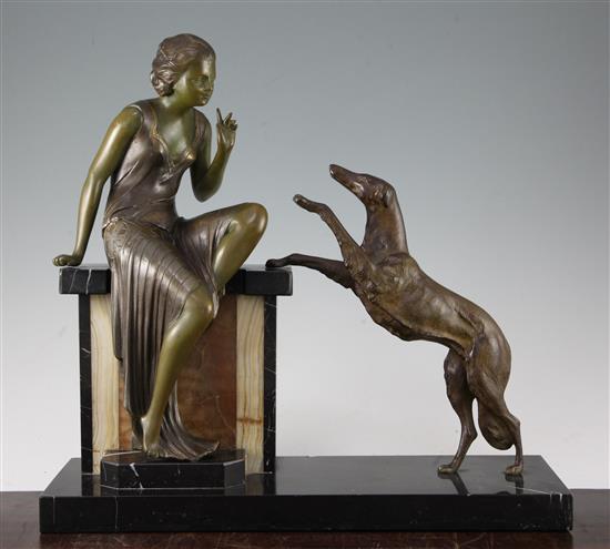 A French Art Deco patinated metal figure group, modelled as a stylish young woman with attendant dog, 17in.